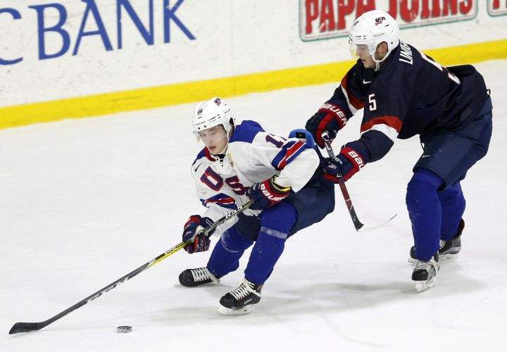In this Sunday, Dec. 17, 2017 photo, United States' Ryan Lindgren, right, checks Kailer Yamamoto during hockey practice in Columbus, Ohio. Expectations will be high when the US under-20 team defends its title on home soil at the World Junior tournament, starting the day after Christmas in Buffalo, N.Y. 