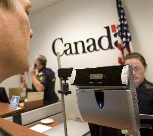 A border services agent does a retinal verification on a traveller at Pearson International Airport in Toronto.