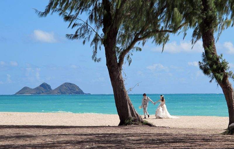 A couple from Japan takes wedding photos at Waimanalo Bay Beach Park, on Wednesday June 10, 2015 in Waimanalo, Hawaii. Residents in the small town have mixed feelings about this beach recently being declared the best public beach in the United States.