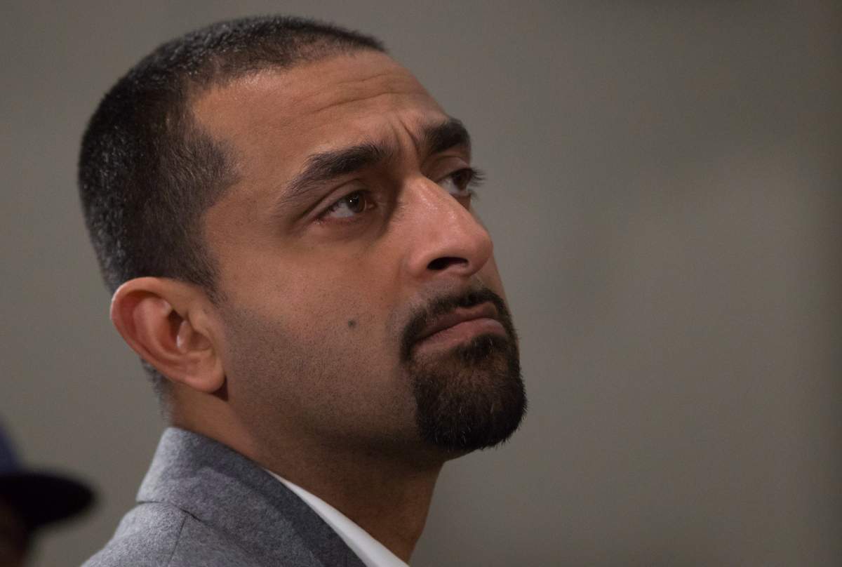 Then-NDP candidate Ravi Kahlon listens as John Horgan speaks to supporters during a campaign stop in Surrey, B.C., on Monday May 8, 2017. 