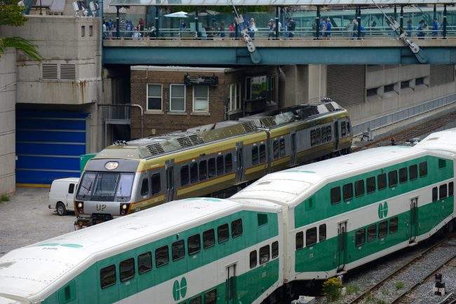 Two trains operated by Metrolinx, the Union Pearson Express and GO Transit pass at Union Station in Toronto, Ont., Aug. 29, 2015. 