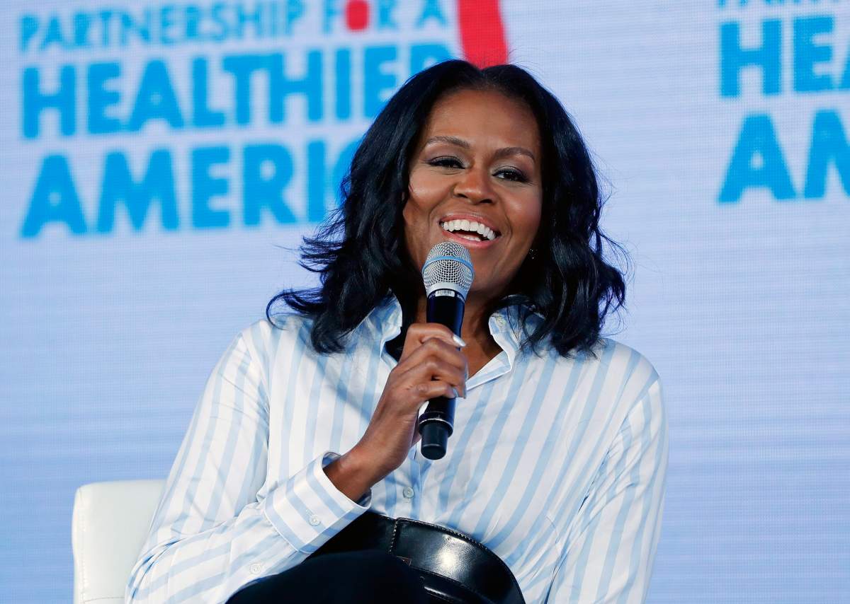 In this May 12, 2017, file photo, former first lady Michelle Obama smiles while speaking at the Partnership for a Healthier American 2017 Healthier Future Summit in Washington. Obama will be speaking in Montreal Monday evening. Feb. 5, 2018.