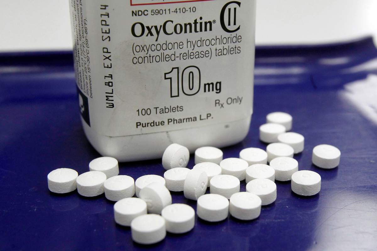 FILE - This Feb. 19, 2013 file photo shows OxyContin pills arranged for a photo at a pharmacy in Montpelier, Vt. 