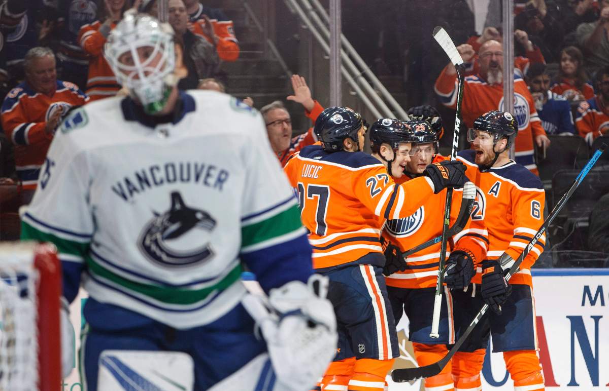 Edmonton Oilers celebrate a goal by Jesse Puljujarvi (98) against Vancouver Canucks goalie Jacob Markstrom (25) during second period NHL action in Edmonton, Alta., on Saturday January 20, 2018. THE CANADIAN PRESS/Jason Franson.