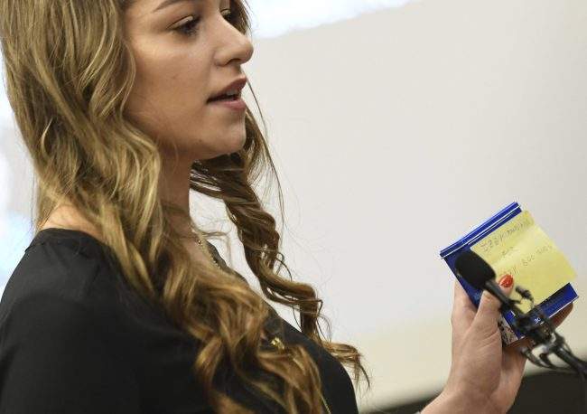 Former gymnast Isabell Hutchins holds up gifts Larry Nassar gave her  as she gives a victim-impact statement Tuesday, Jan. 23, 2018, during the sixth day of testimony in Lansing, Mich.
