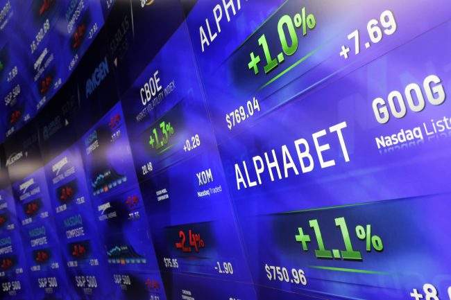 Electronic screens post prices of Alphabet stock at the Nasdaq MarketSite in New York, Feb. 1, 2016.

