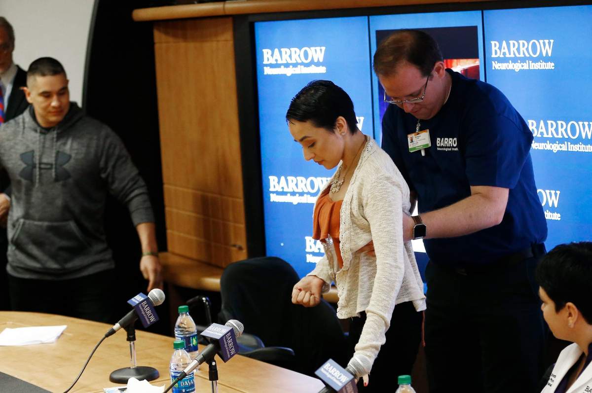 Las Vegas mass shooting victim Jovanna Calzadillas, center, is helped by therapist Ammon Lovell, right, as Jovanna’s husband Frank Calzadillas, left, arrives for a news conference prior to her release from the Barrow Neurological Institute at Dignity Health St. Joseph’s Hospital, Wednesday, Jan. 24, 2018, in Phoenix. The Mesa, Ariz., resident, and young mother of two children, was shot in the head during the nation’s deadliest mass shooting on Sunday, Oct. 1, 2017. (AP Photo/Ross D. Franklin)