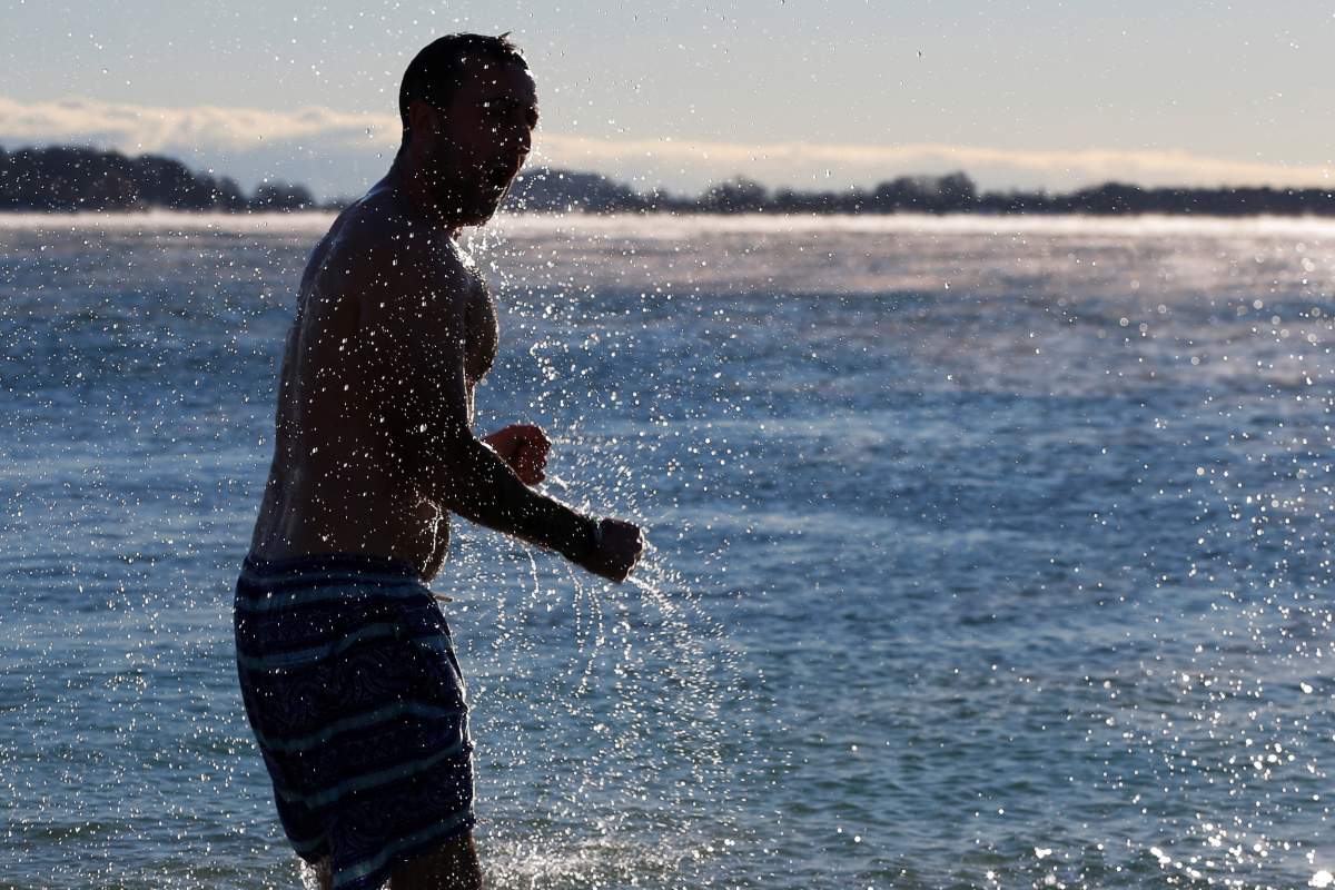 A man splashes in the ocean during the annual New Year’s Day L Street Brownies Polar Bear Plunge, with the air temperatures at zero degrees Fahrenheit, in Boston, Massachusetts, U.S., January 1, 2018. REUTERS/Brian Snyder