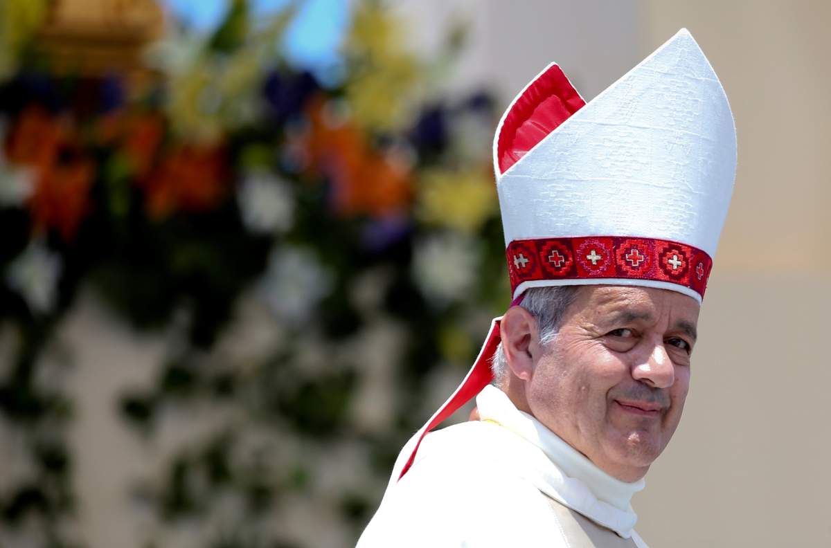 Bishop Juan Barros looks on as Pope Francis leaves at the end of a mass at the Lobito beach in Iquique, Chile, January 18, 2018. REUTERS/Alessandro Bianchi