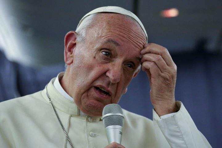Pope Francis gestures during a news conference on board the plane during his flight back from a trip to Chile and Peru, Jan. 22, 2018. 