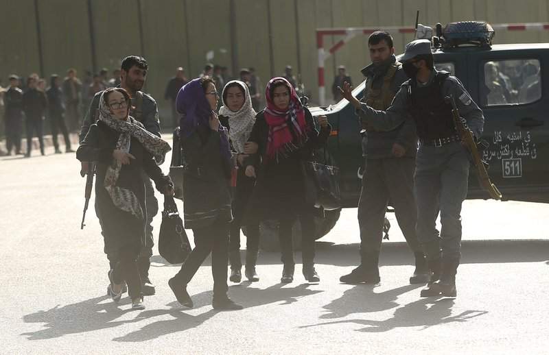 Women try to enter the site of a deadly suicide attack to look for relatives in downtown Kabul, Afghanistan, Saturday, Jan. 27, 2018.