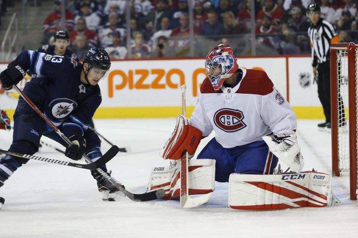 Winnipeg Jets' Brandon Tanev (13) attempts to get the puck past Montreal Canadiens goaltender Al Montoya (35) during second period NHL action in Winnipeg on Saturday, November 4, 2017. 
