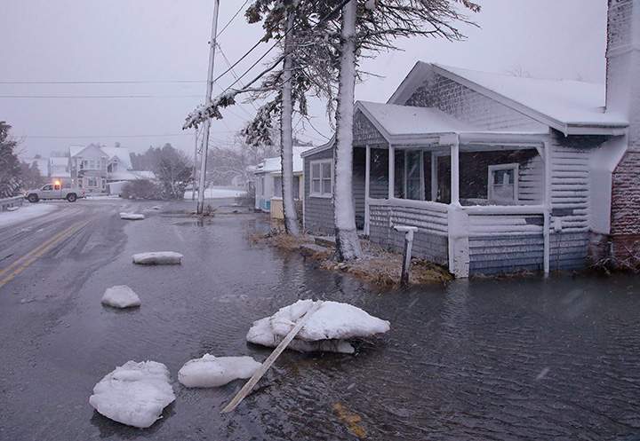 Large chunks of sea ice pictured in front of a flooded house on Jan. 4, 2018, in Marshfield, Mass.