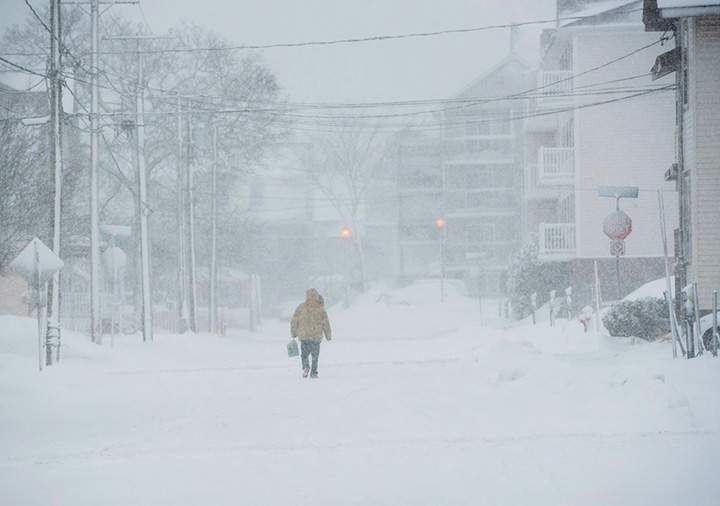 A pedestrian walks down the middle of a road in downtown Moncton, N.B., January 4, 2018.