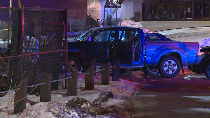 Damaged police vehicle and stolen truck at Southern Alberta Jubilee Auditorium parking lot, Saturday, Jan. 6, 2018.. 