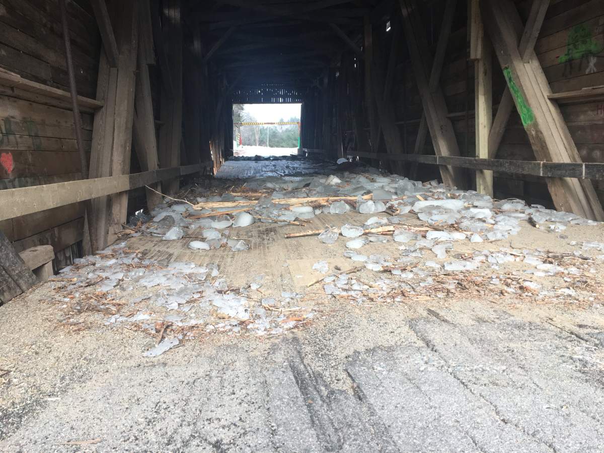 Ice chunks remain where holes were punched through the bridge by the rising water