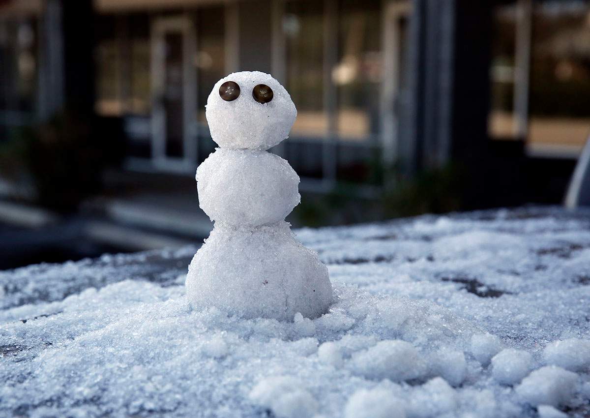 A snowman, built by Marty Ritter, sits on the back of his truck outside Morrow Cleaners, Wednesday, Jan. 3, 2018, in Tallahassee, Fla.