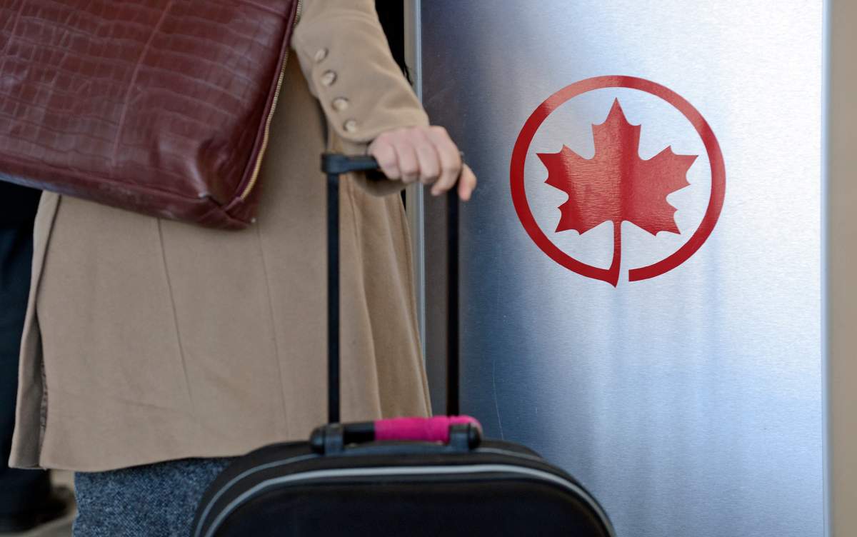 The Air Canada logo is seen next to a check-in area at Pearson International Airport in Toronto, Ontario, Canada, on Wednesday, Feb. 6, 2013. 