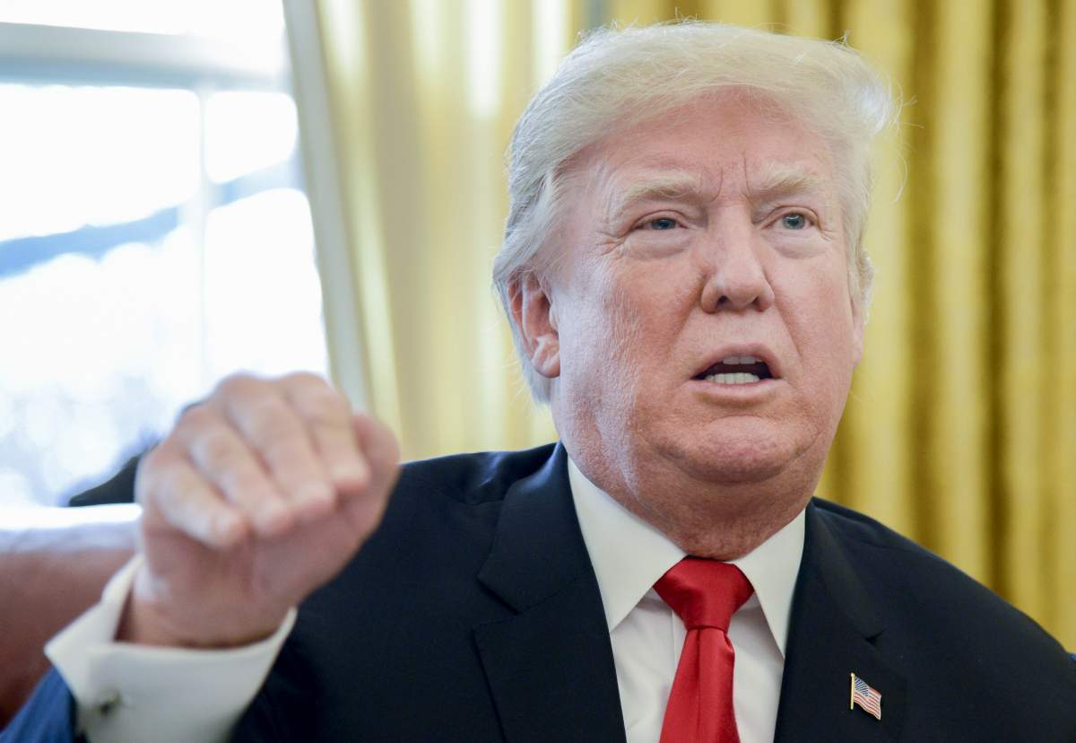 U.S. President Donald Trump speaks to members of the media in the Oval Office of the White House in Washington, D.C., U.S., on Friday, Dec. 22, 2017.
