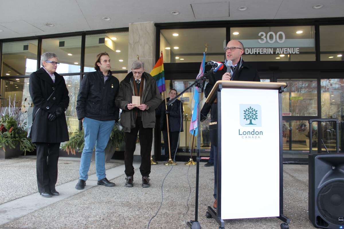 Mayor Matt Brown apologizes to the LGBTQ2 community before a large crowd at city hall.