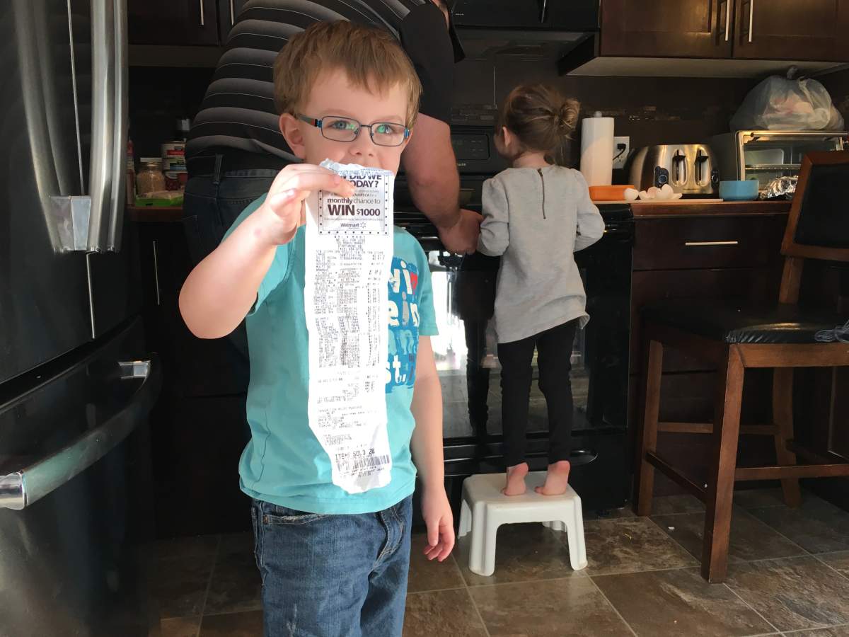 4-year-old Mylo shows off the family\’s first grocery bill falling within their $50 per week budget.