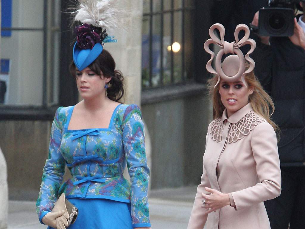 Princess Beatrice of York (R) and Princess Eugenie of York (L) arrive to attend the royal wedding of Prince William at Westminster Abbey on April 29, 2011 in London, England.