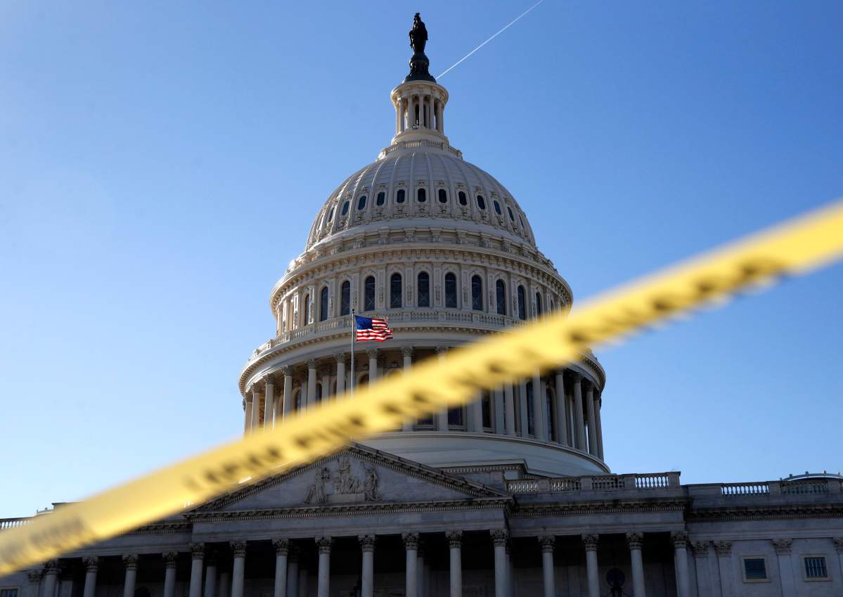 Police tape marks a secured area of the Capitol, Friday, Jan. 19, 2018, in Washington.