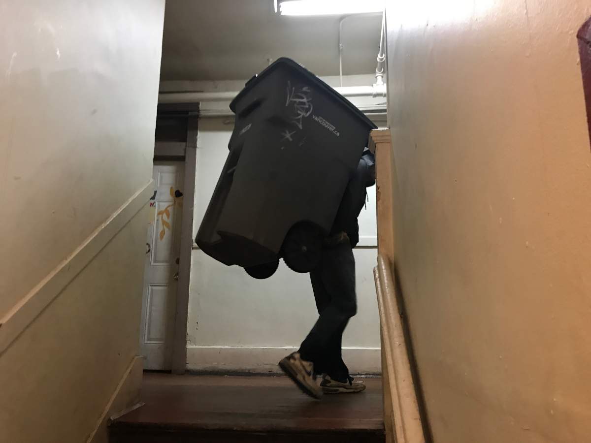 This SRO resident has to carry a large bin up several flights of stairs because the elevator hasn't worked for nearly two weeks.