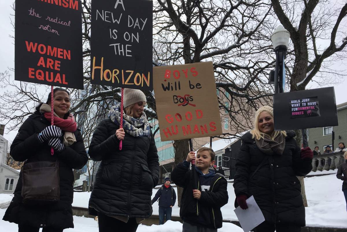Gabe Hart, 8, holds a sign that reads "boys will be good humans" at the women's march at Halifax's Grand Parade.