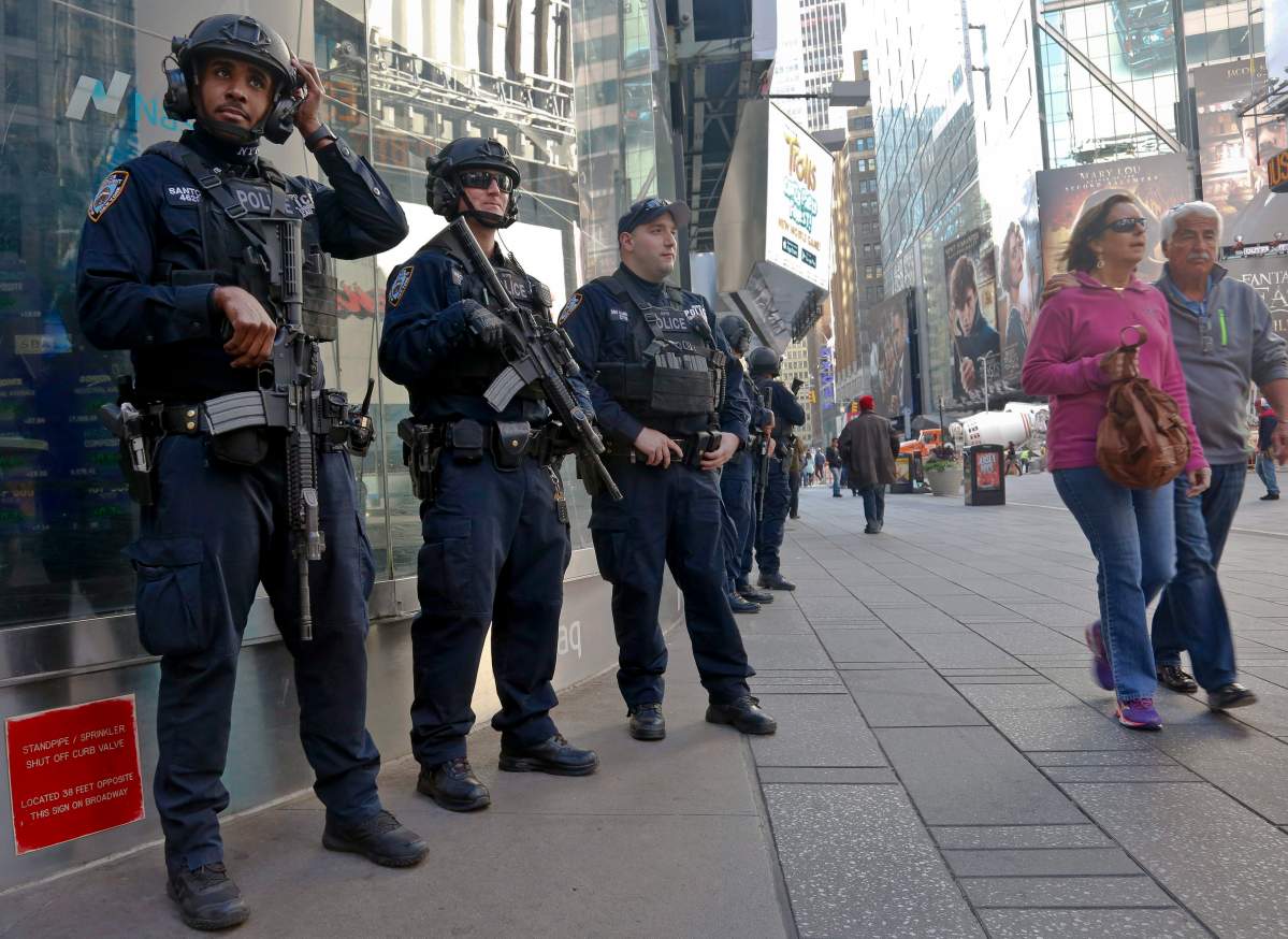 NYPD anti-terror police patrol Times Square, Friday Nov. 4, 2016, in New York.  (AP Photo/Bebeto Matthews).