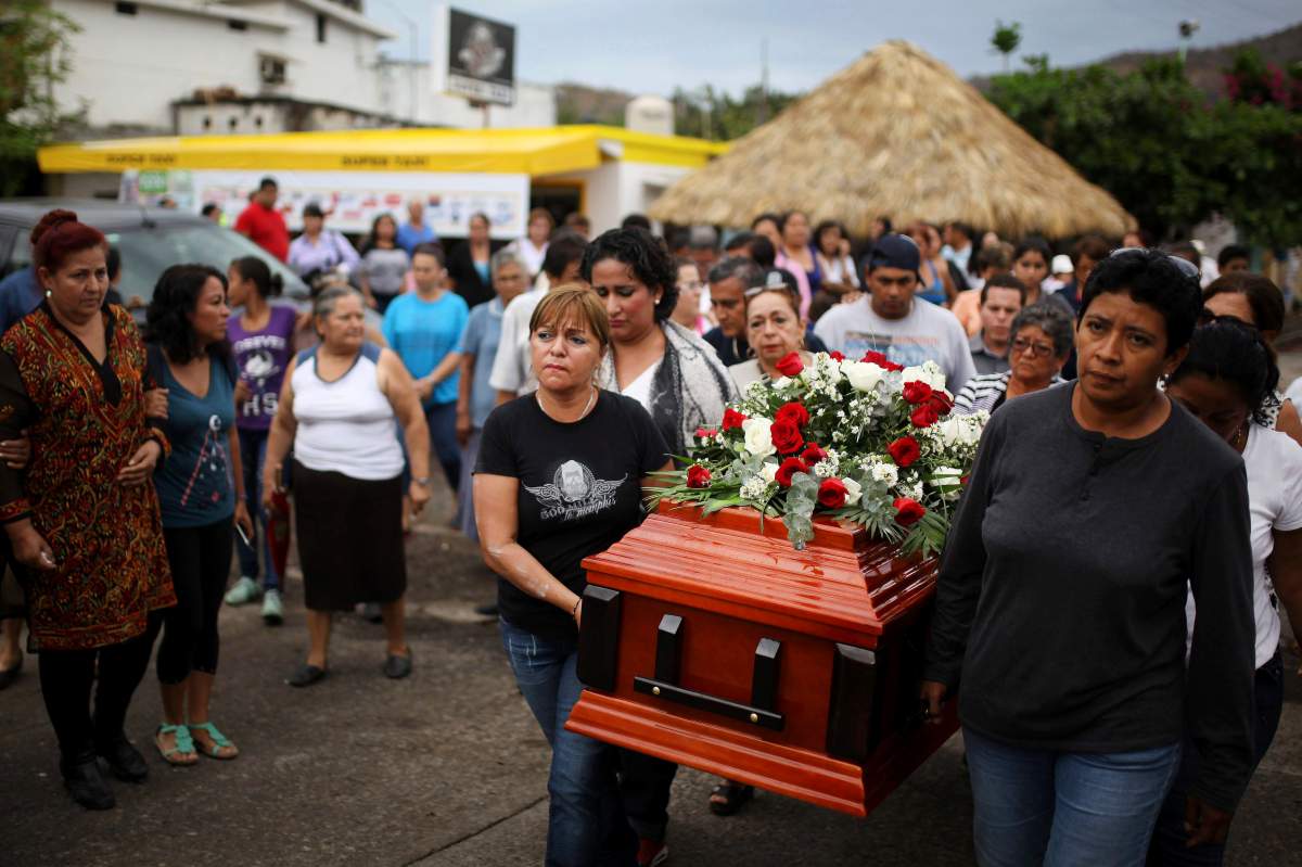 In this March 8, 2017, photo, members of the Solecito search group carry the coffin of Pedro Huesca, a police detective who disappeared in 2013 and was recently found in a mass grave linked to a drug cartel.