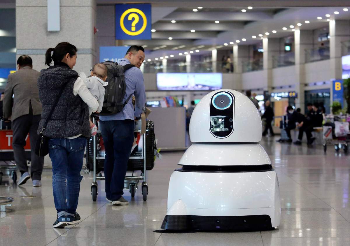 In this April 10, 2017, photo, an LG Electronics’s cleaning robot moves to clean the floor at the Incheon International Airport in Incheon, South Korea.