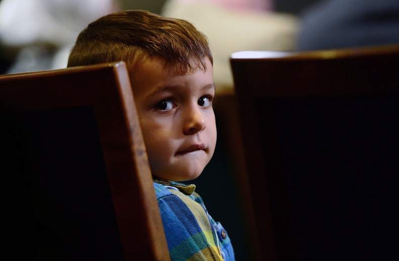 Sebastian Khan, 3, of London, Ontario sits patiently as his mother talks about his name being on the Canada's No Fly List during a press conference on Parliament Hill in Ottawa last November.