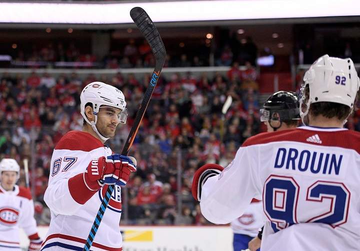 In this file photo, Montreal Canadiens left wing Max Pacioretty (67) celebrates his goal with center Jonathan Drouin (92) during the second period of an NHL hockey game.  Drouin suffered an upper body injury in a game against Anaheim in Montreal. Saturday, Feb. 3, 2018.