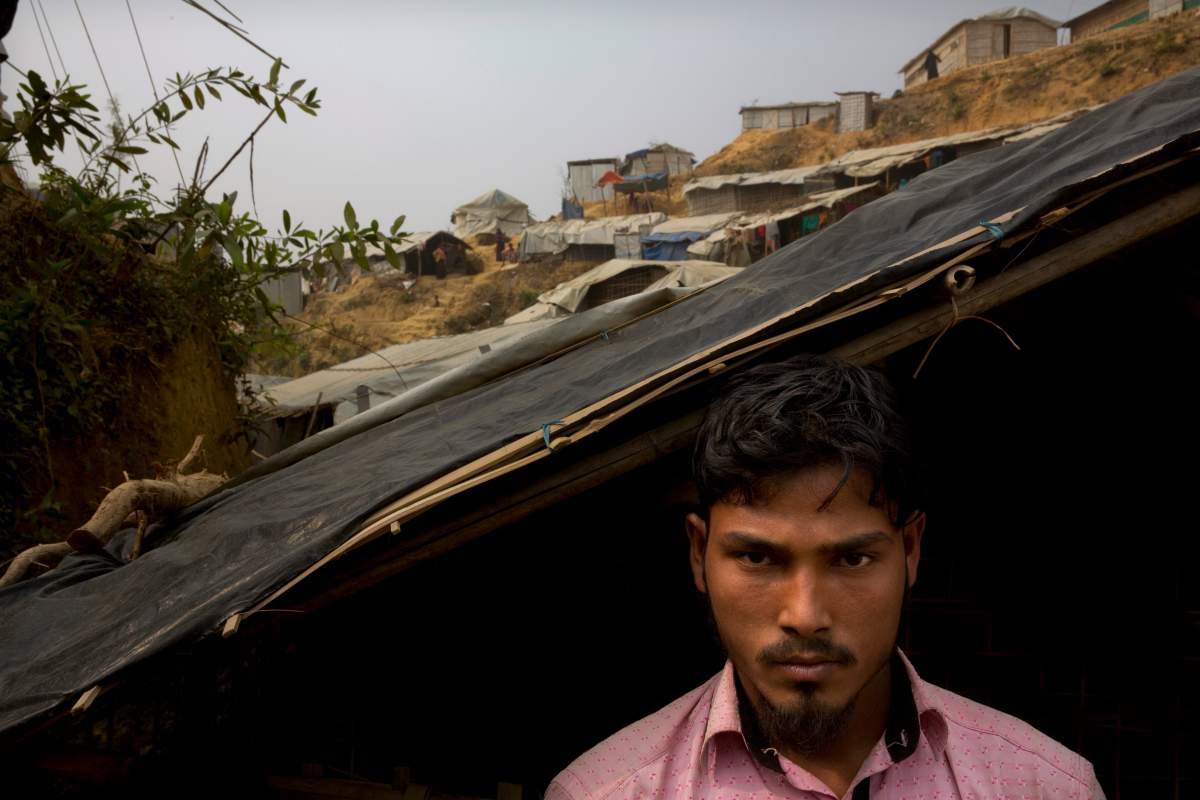 In this Jan. 14, 2018 photo, Rohingya Muslim refugee Mohammad Lalmia, 20, from the Myanmar village of Gu Dar Pyin poses for a portrait in Balukhali refugee camp, Bangladesh. 