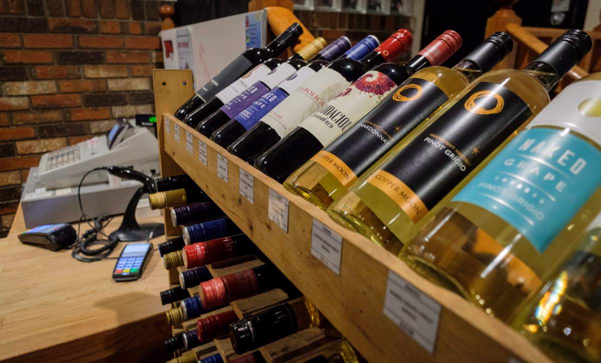 Bottles of British Columbia wine on display at a liquor store in Cremona, Alta., Wednesday, Feb. 7, 2018. Alberta is banning the import of British Columbia wines in response to what Alberta Premier Rachel Notley sees as moves to try to scuttle the Trans Mountain pipeline project. THE CANADIAN PRESS/Jeff McIntosh.