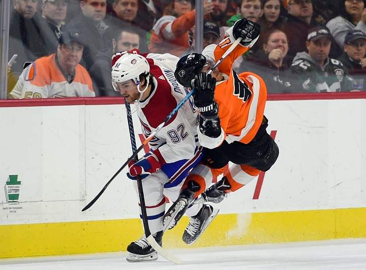 Philadelphia Flyers' Travis Konecny, right, is tripped by Montreal Canadiens' Jonathan Drouin (92) during the third period of an NHL hockey game Thursday, Feb. 8, 2018, in Philadelphia. The Flyers won 5-3. 