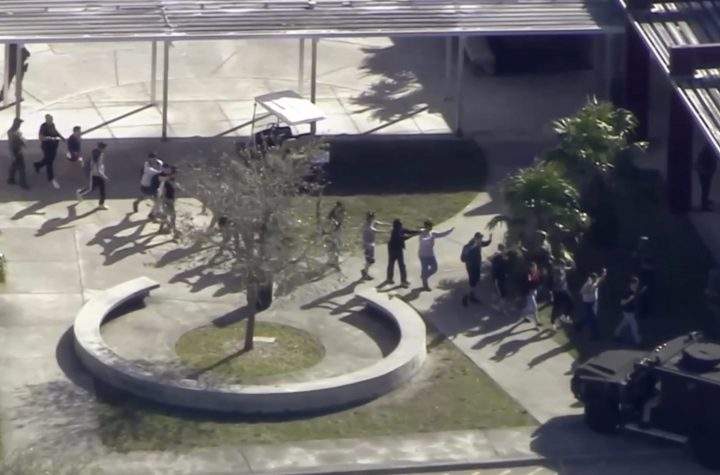 In this frame grab from video provided by WPLG-TV, students from the Marjory Stoneman Douglas High School in Parkland, Fla., evacuate the school following a shooting there on Wednesday, Feb. 14, 2018.