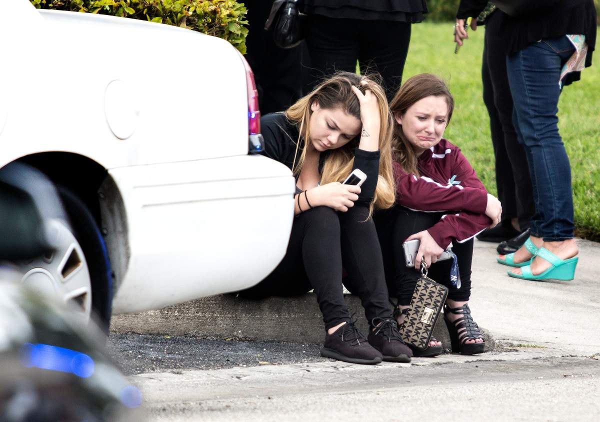 Two girls crying after the viewing service for Gina Montalto, one of the victims of the shooting, in the Kraeer Funeral Home in Coral Springs. 