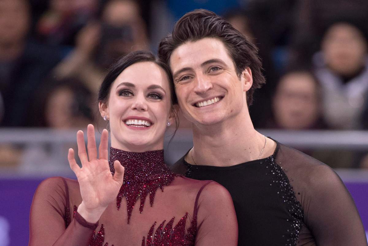 Ice dance gold medalists Canada's Tessa Virtue and Scott Moir look up to the crowd during victory ceremonies at the Pyeongchang Winter Olympics Tuesday, February 20, 2018 in Gangneung, South Korea. 