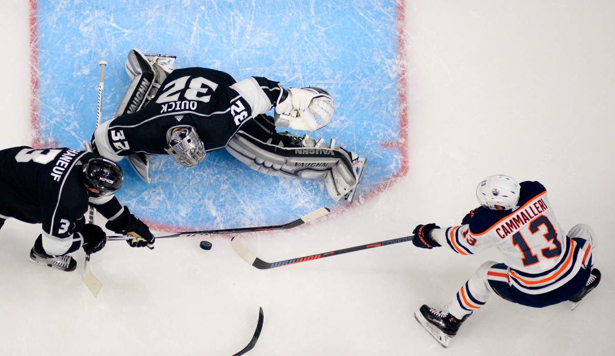 Edmonton Oilers left wing Michael Cammalleri, right, tries to get a shot in on Los Angeles Kings goaltender Jonathan Quick, center, as defenseman Dion Phaneuf helps Quick during the second period of an NHL hockey game, Saturday, Feb. 24, 2018, in Los Angeles. (AP Photo/Mark J. Terrill).