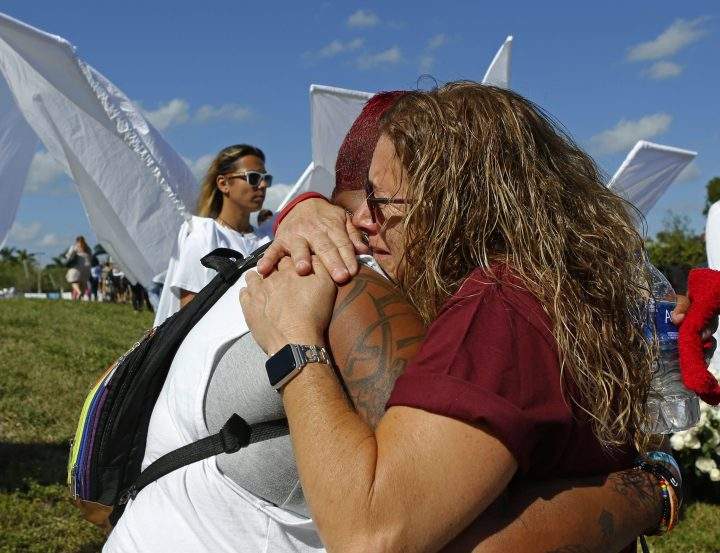 Pulse shooting survivor India Godman, left, hugs Wendy Garrity at Marjory Stoneman Douglas High School.