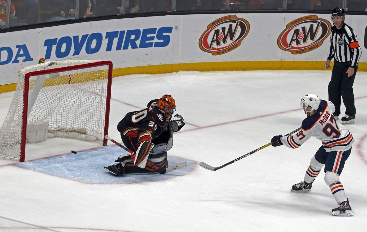 Edmonton Oilers center Connor McDavid (97) gets the winning shootout goal past Anaheim Ducks goalie Ryan Miller Edmonton Oilers of an NHL hockey game in Anaheim, Calif., Sunday, Feb. 25, 2018. The Oilers won in a shootout, 6-5. (AP Photo/Reed Saxon).