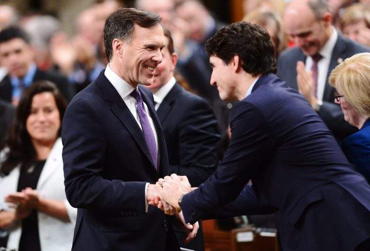 Finance Minister Bill Morneau shakes hands with Prime Minister Justin Trudeau as he arrives in the House of Commons prior to tabling the federal budget.
