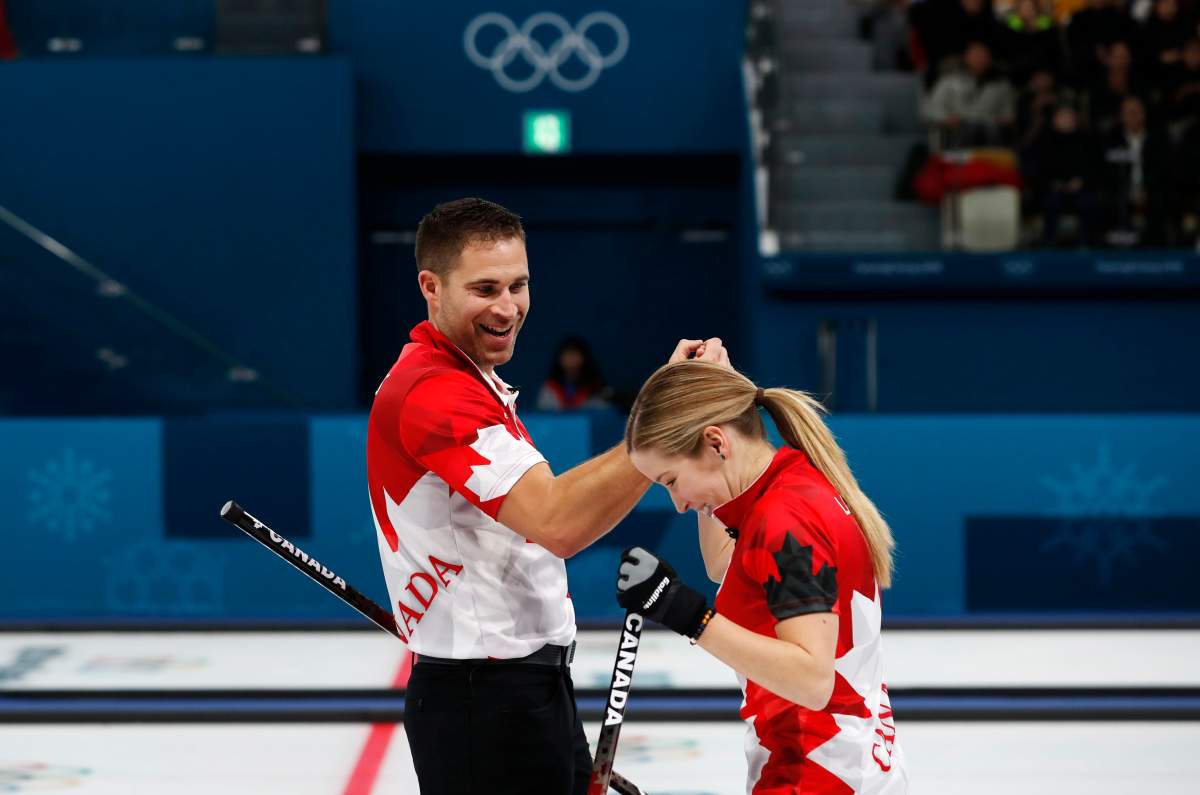 Curling – Pyeongchang 2018 Winter Olympics – Mixed Doubles Semi-final – Canada v Norway – Gangneung Curling Center – Gangneung, South Korea – February 12, 2018 – Kaitlyn Lawes and John Morris of Canada celebrate. REUTERS/Cathal McNaughton