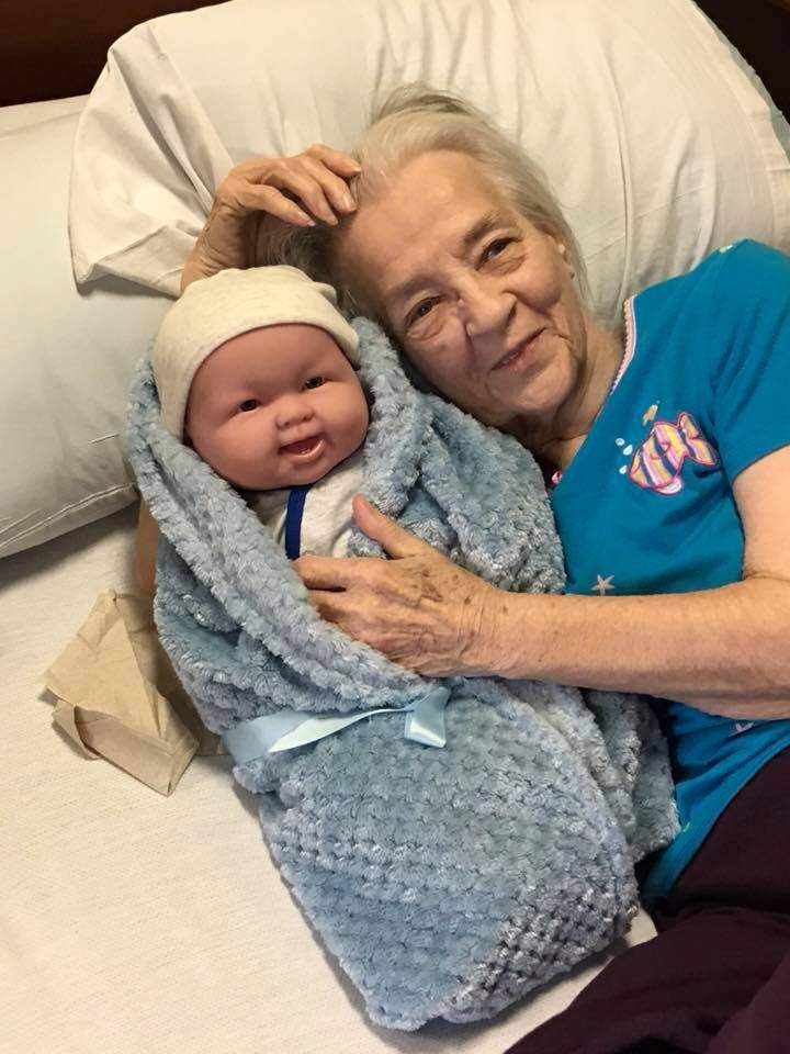 Alzheimer’s patients light up after receiving dolls and plush puppies for therapy - image