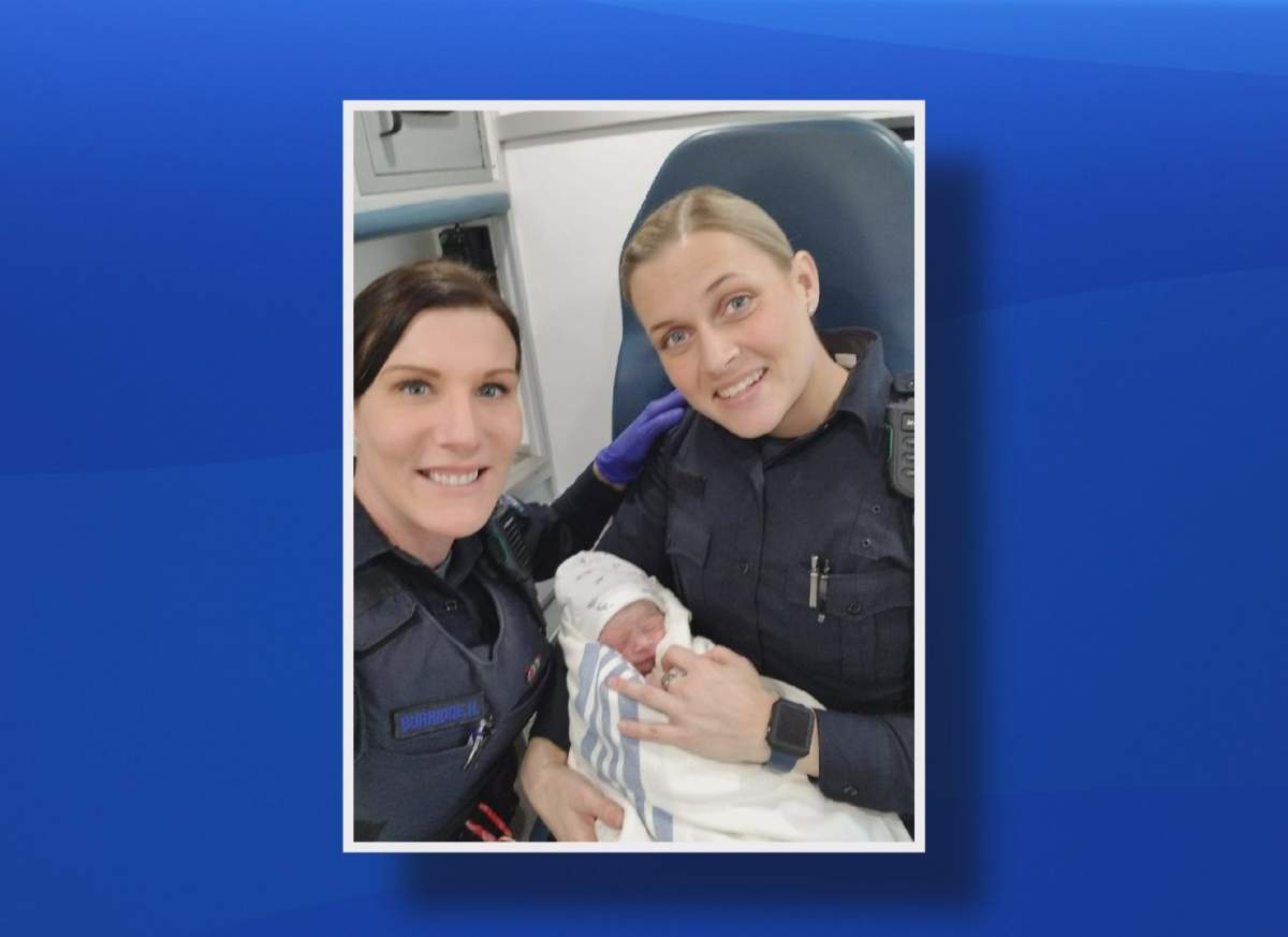 Halifax Regional Police Const. Hannah Burridge and Const. Kali MacDonald pose with the baby they helped deliver.