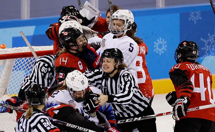 Officials separate players at the end of the game between Canada and the U.S. at the Kwandong Hockey Centre, Gangneung, South Korea on Feb. 15, 2018.