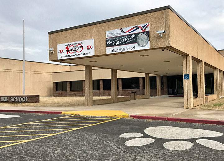 In this Feb. 24, 2018 photo, the main entrance of Dalton High School is shown, in Dalton, Ga. Police in Georgia say officers are responding to reports of shots fired at the high school and a teacher who may have been barricaded in a classroom is in custody. 