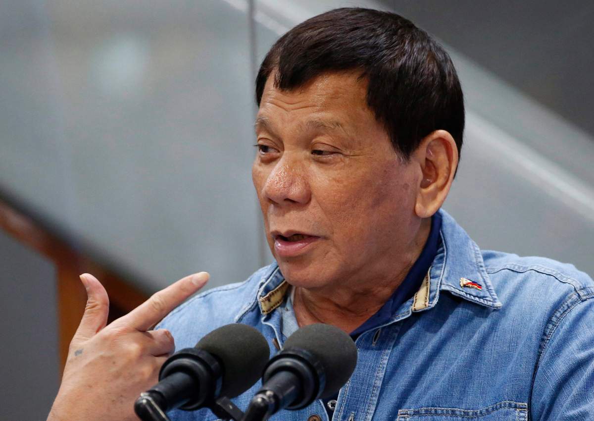 Rodrigo Duterte gestures while addressing Filipino Overseas Workers who were repatriated from Kuwait, Tuesday, Feb. 13, 2018 .